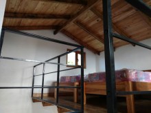 The second floor is built of wood and there are three single beds